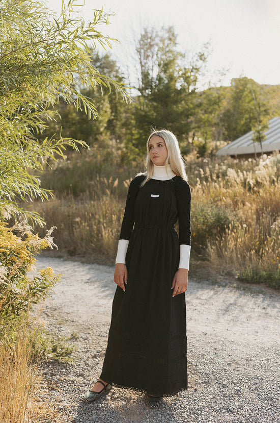 Elw110a black knit center with ribbon on turtleneck, bottom of sleeves and band of shirt