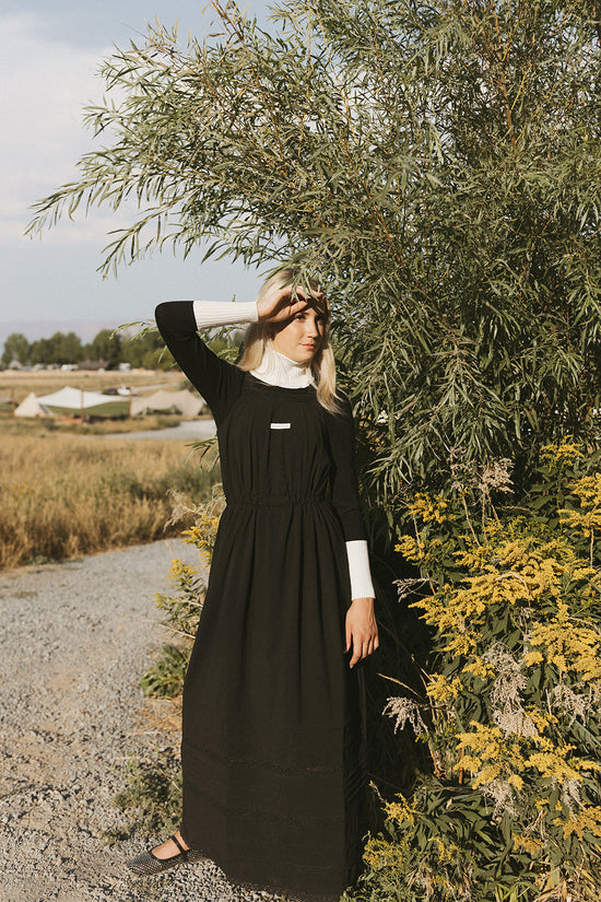 Elw110a black knit center with ribbon on turtleneck, bottom of sleeves and band of shirt